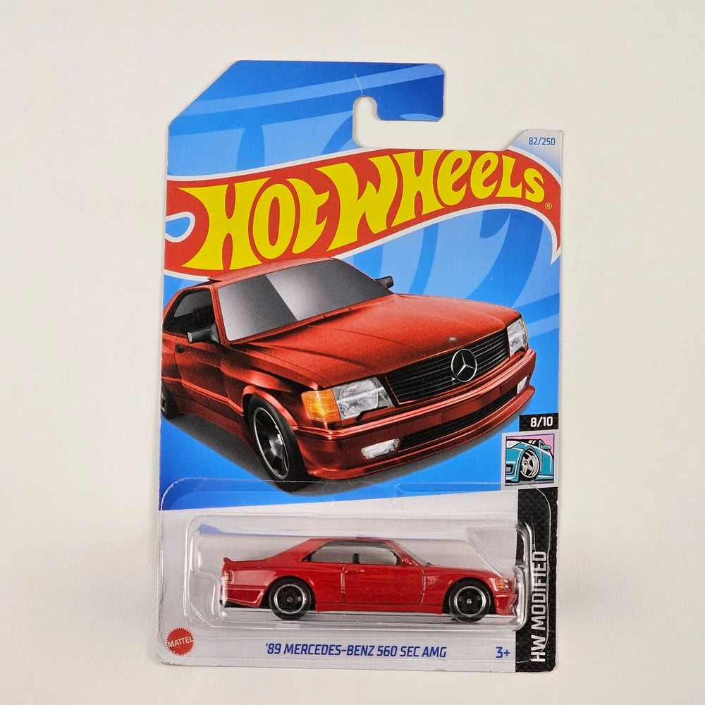 Hot Wheels '89 Mercedes-Benz 560 SEC AMG toy car in packaging on a light gray background